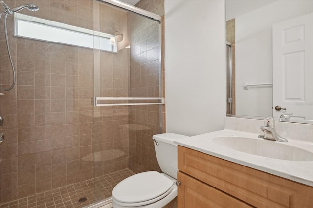 bathroom featuring vanity, toilet, and walk in shower