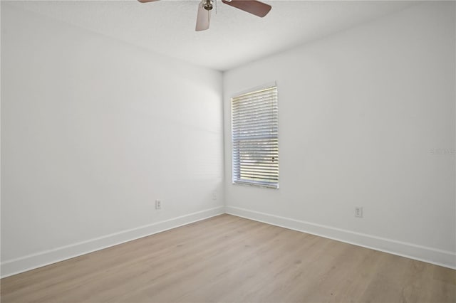 spare room featuring light wood-type flooring and ceiling fan