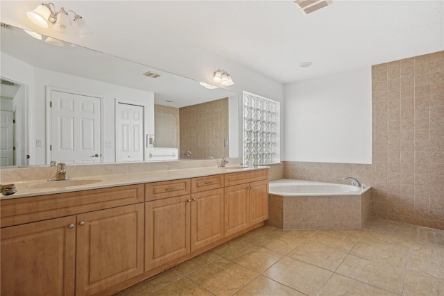 bathroom featuring vanity, tiled bath, tile patterned floors, and tile walls