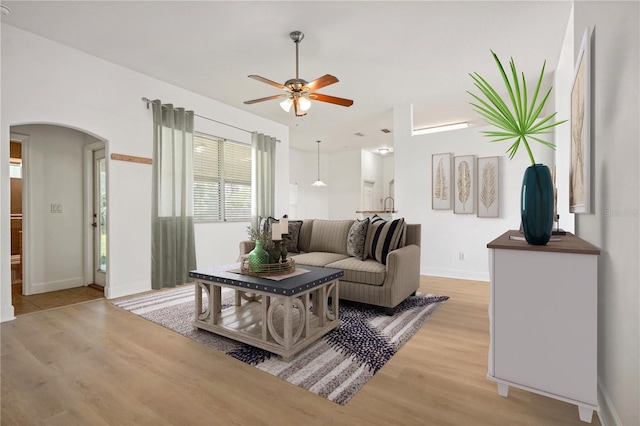 living room featuring light hardwood / wood-style flooring and ceiling fan