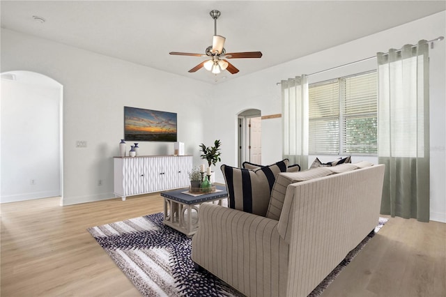 living room featuring light wood-type flooring and ceiling fan