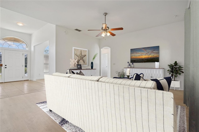 living room with light tile patterned floors and ceiling fan