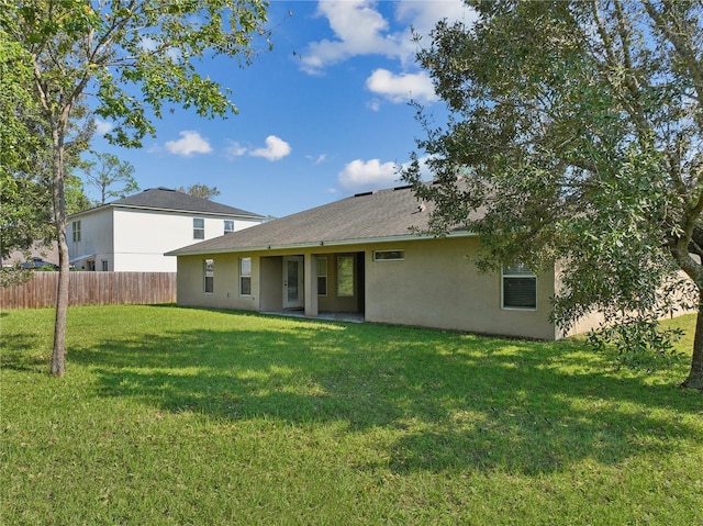 back of house featuring a yard