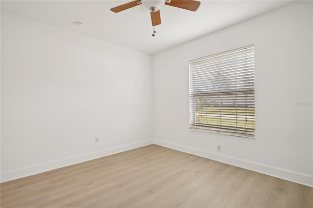 spare room with light wood-type flooring and ceiling fan