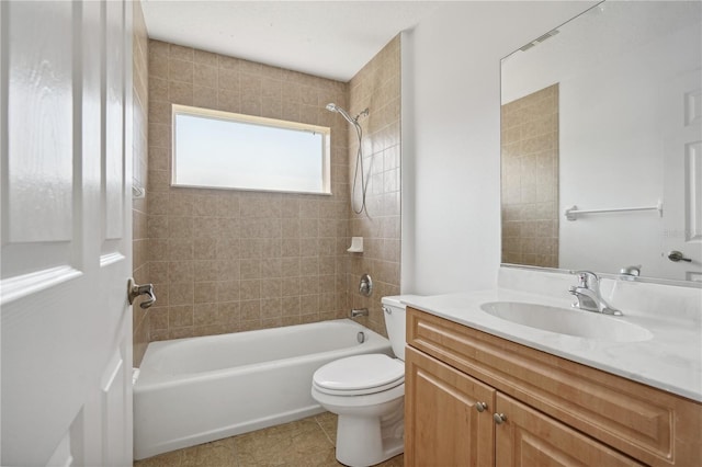 full bathroom with tiled shower / bath, vanity, toilet, and tile patterned floors