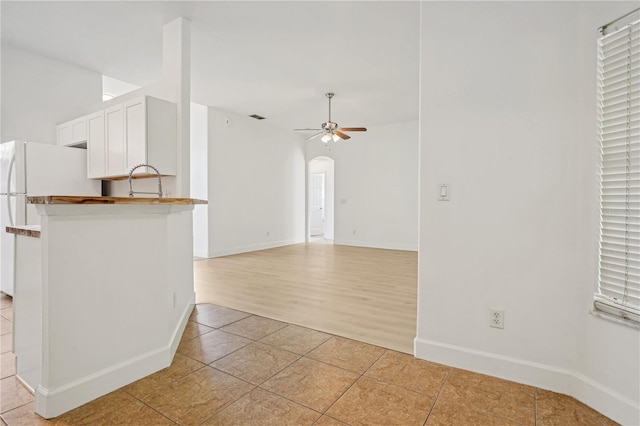 interior space featuring light wood-type flooring and ceiling fan