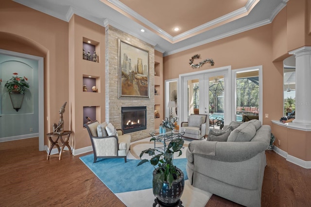 living room featuring french doors, dark wood-type flooring, and ornamental molding