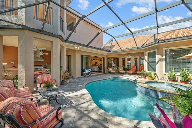 view of swimming pool featuring a lanai, ceiling fan, a patio area, and an in ground hot tub