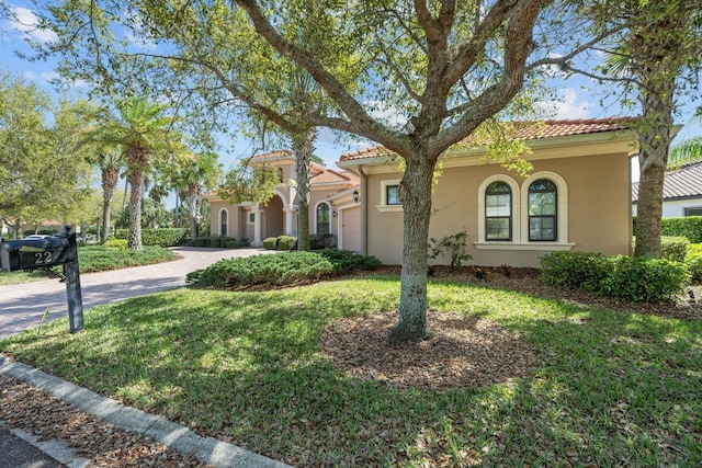 mediterranean / spanish-style house with a front lawn