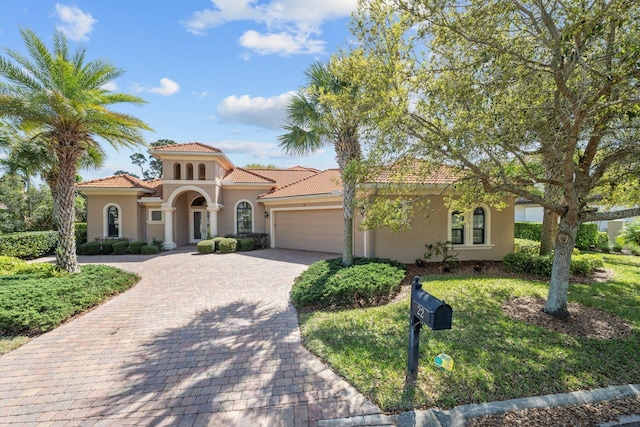 mediterranean / spanish-style house with a garage