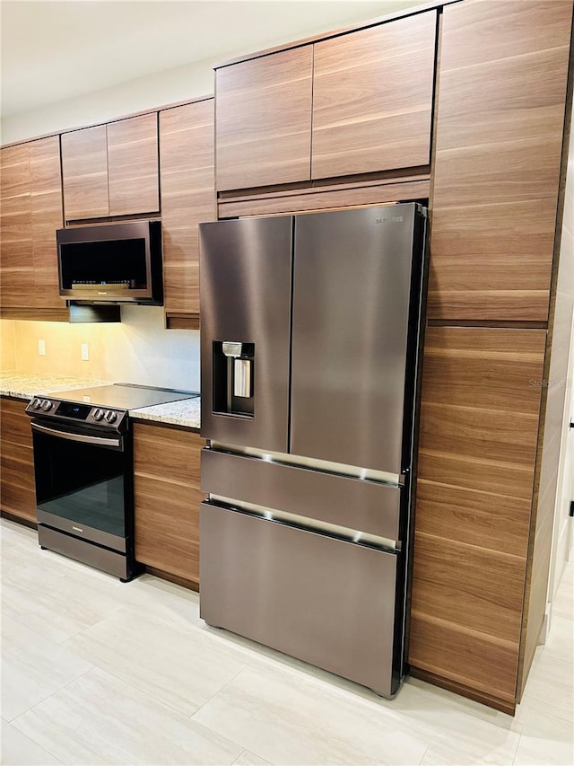 kitchen with stainless steel appliances, light stone countertops, light tile patterned flooring, and tasteful backsplash