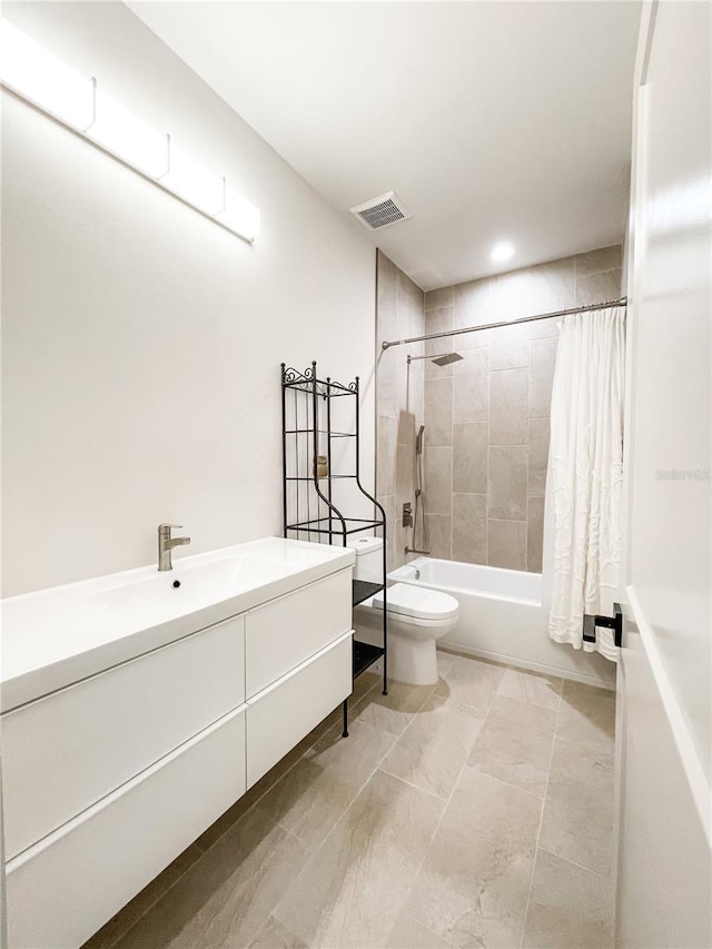 full bathroom with vanity, shower / bath combo, and toilet