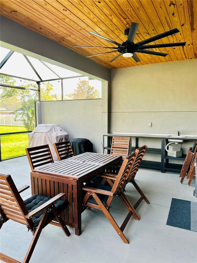 view of patio featuring ceiling fan and a lanai