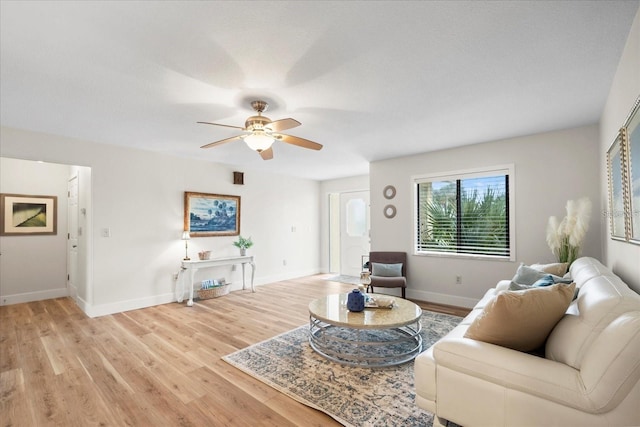 living room featuring ceiling fan and light hardwood / wood-style flooring