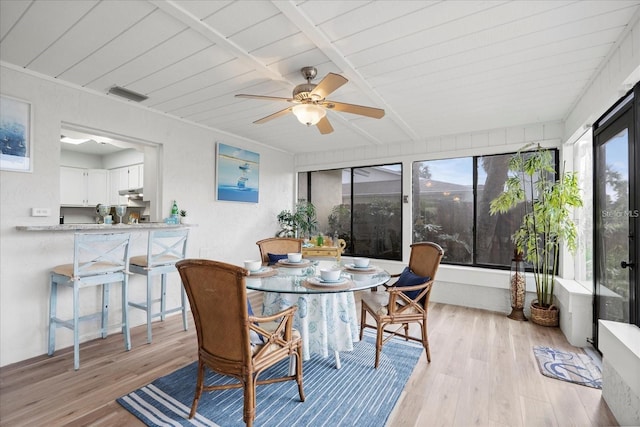 sunroom with ceiling fan and wood ceiling