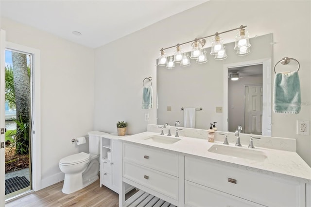 bathroom featuring hardwood / wood-style floors, vanity, and toilet