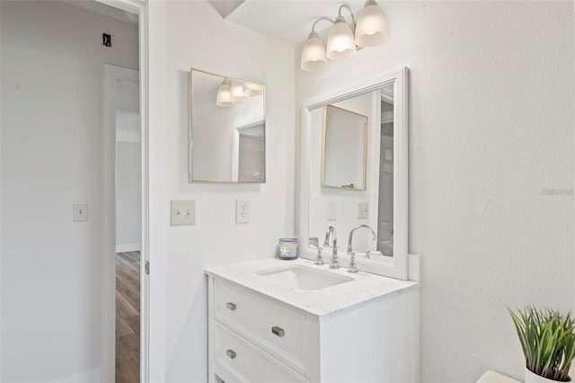 bathroom featuring hardwood / wood-style flooring and vanity