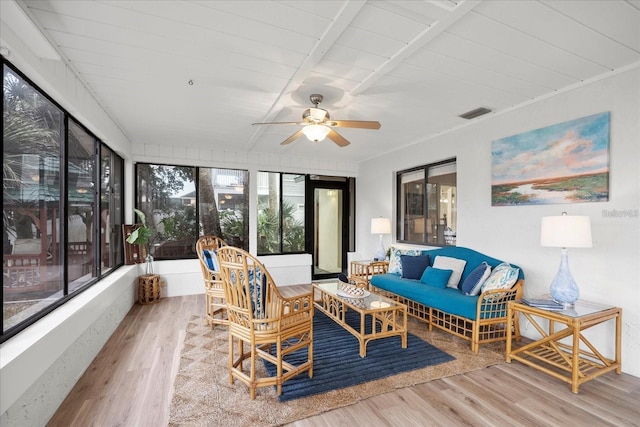 sunroom featuring ceiling fan and wood ceiling