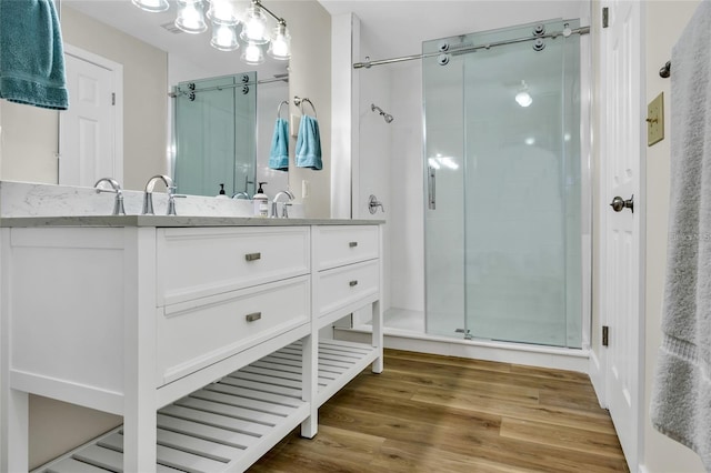 bathroom with vanity, hardwood / wood-style flooring, and an enclosed shower