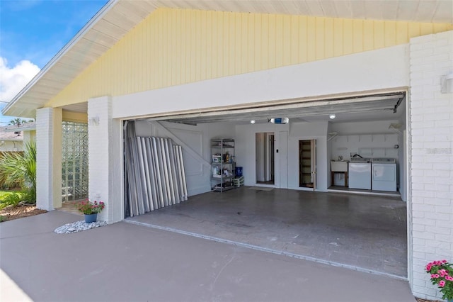 garage with separate washer and dryer and sink