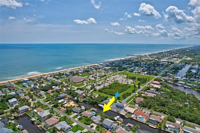 drone / aerial view with a beach view and a water view