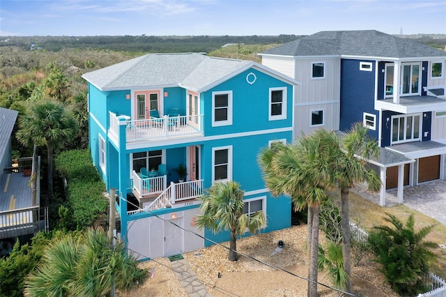 view of front of property with a balcony and a garage