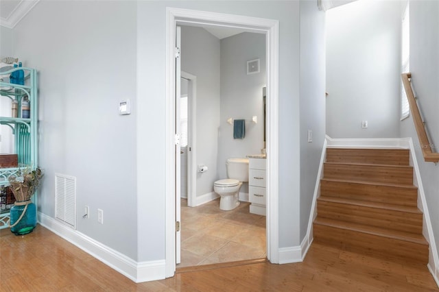 interior space with ornamental molding and hardwood / wood-style flooring