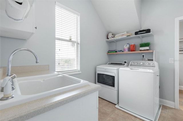 laundry room with washer and dryer, sink, and light tile patterned floors