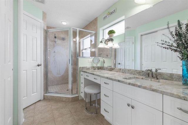 bathroom featuring vanity, tile patterned flooring, and an enclosed shower