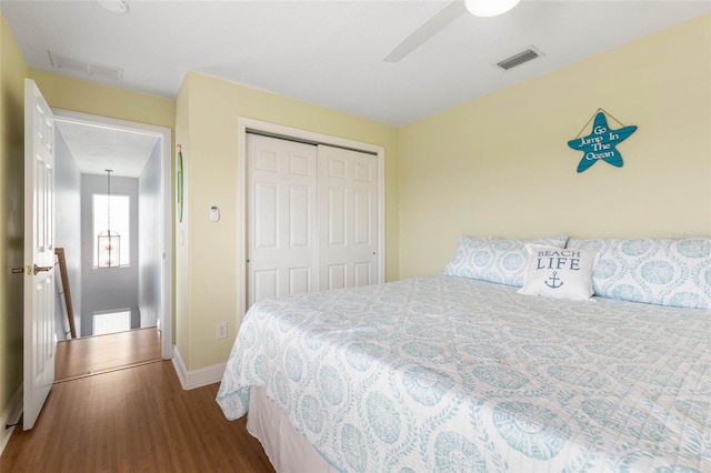 bedroom featuring a closet, wood-type flooring, and ceiling fan