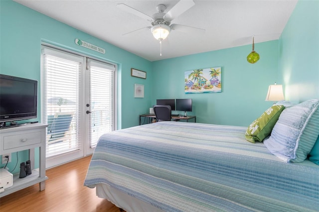 bedroom featuring light hardwood / wood-style flooring, access to outside, multiple windows, and ceiling fan