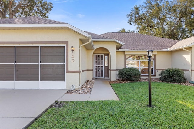 view of front of house with a garage and a front lawn