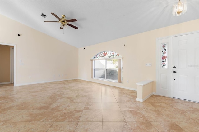 foyer entrance with lofted ceiling, light tile patterned floors, and ceiling fan