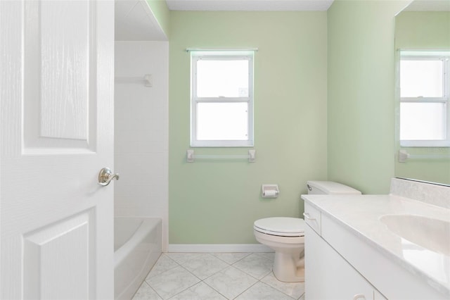 bathroom with toilet, vanity, and tile patterned floors