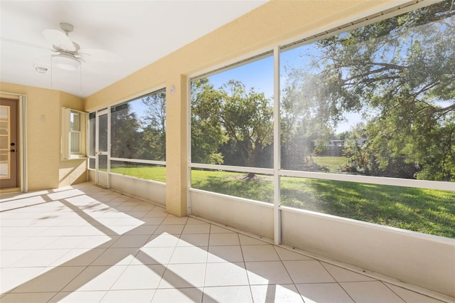 unfurnished sunroom with ceiling fan