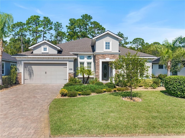 view of front of home with a garage and a front lawn