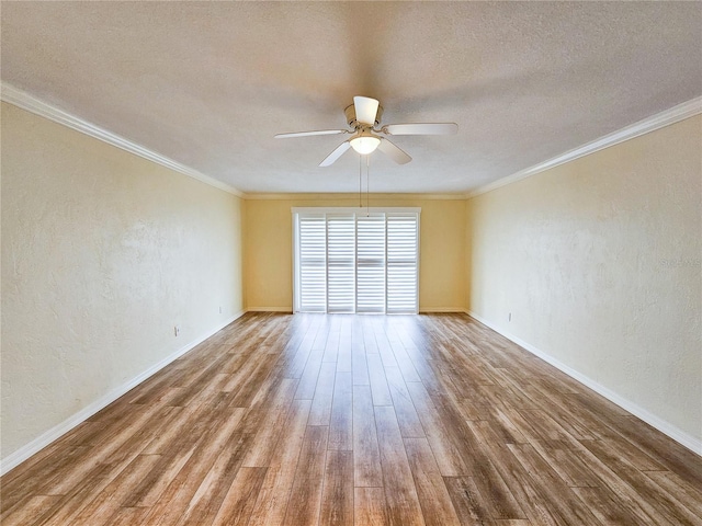 spare room with crown molding, wood-type flooring, and ceiling fan