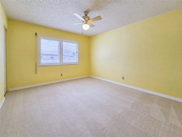 empty room featuring light carpet, a textured ceiling, and ceiling fan