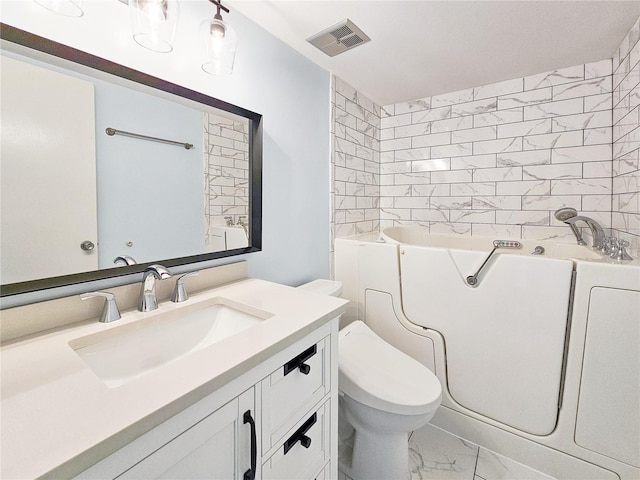 bathroom with vanity, toilet, and a washtub