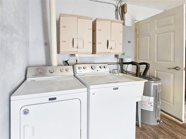 laundry area featuring electric water heater, independent washer and dryer, and hardwood / wood-style flooring