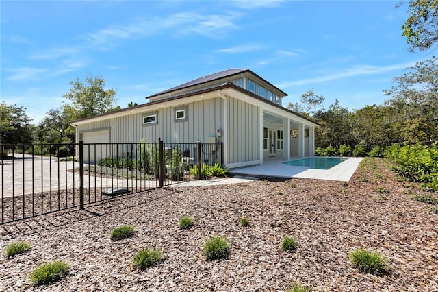 back of property featuring a patio and a garage