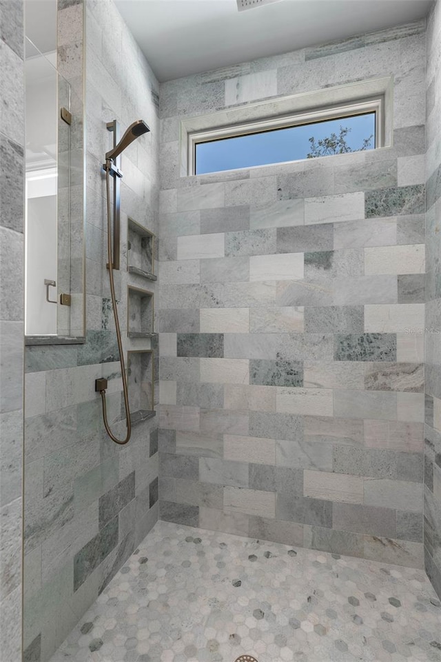 bathroom with a tile shower