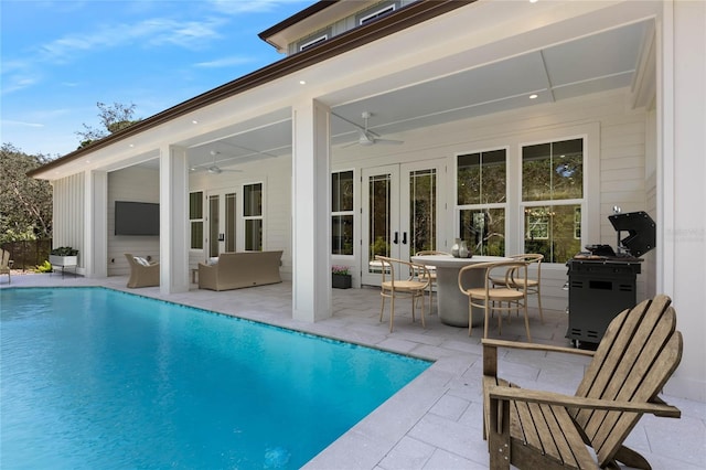 view of swimming pool with an outdoor living space, ceiling fan, french doors, and a patio area