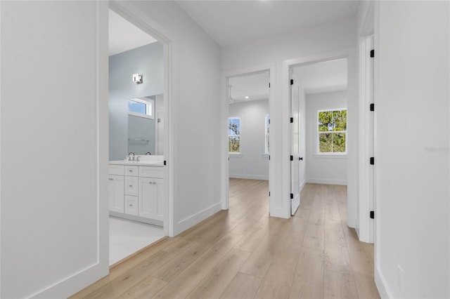 hallway with light hardwood / wood-style floors