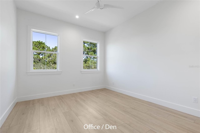 spare room with light wood-type flooring and ceiling fan