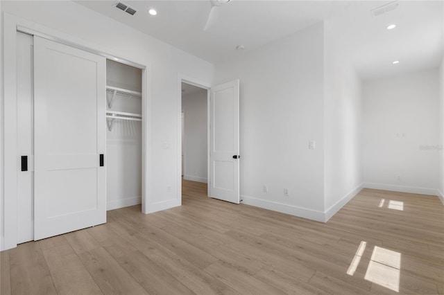 unfurnished bedroom featuring light hardwood / wood-style flooring and ceiling fan