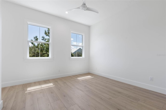 empty room featuring ceiling fan and light hardwood / wood-style flooring