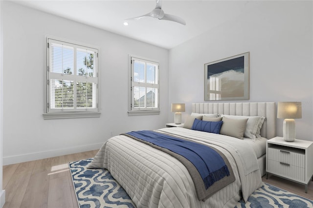 bedroom with ceiling fan and light hardwood / wood-style flooring