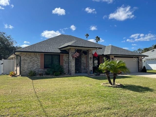 view of front of home with a front lawn and a garage