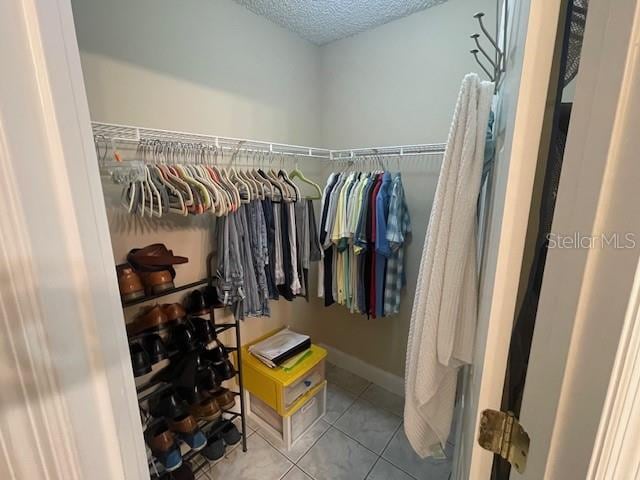 spacious closet featuring light tile patterned flooring